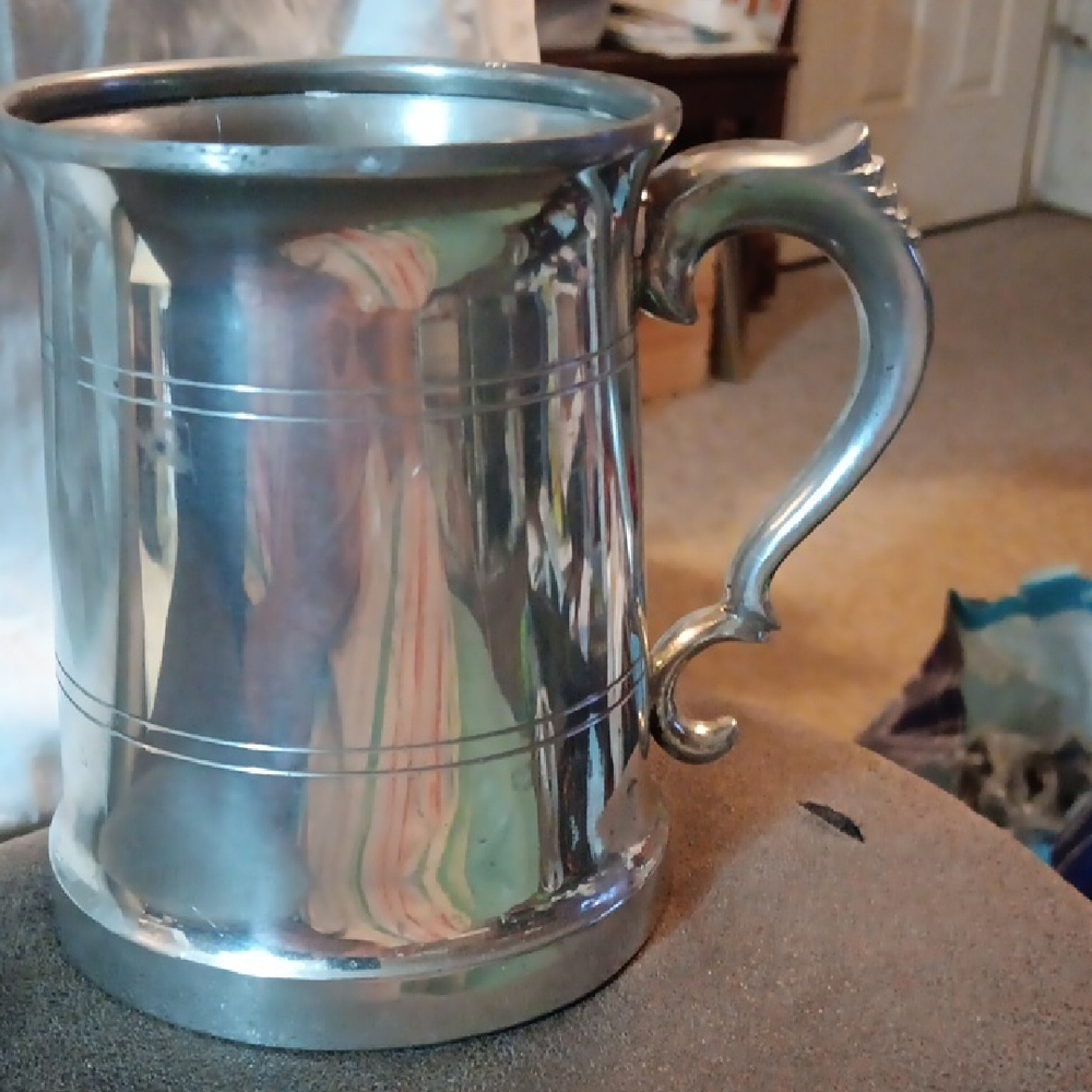 Elegant Silver Mug with Ornate Handle